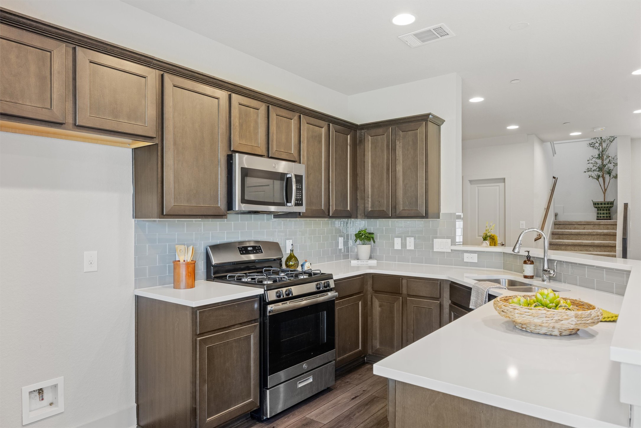 2056 Local Rebel Street Leander, TX 78641 - Photo 12 of 40 a kitchen that has a sink and a stove in it