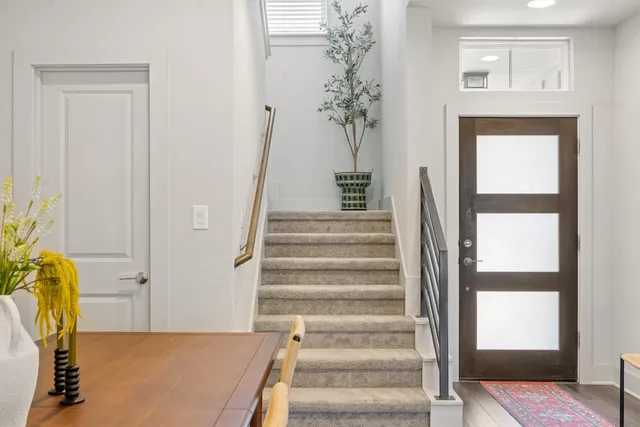 a view of entryway with wooden floor and a chandelier