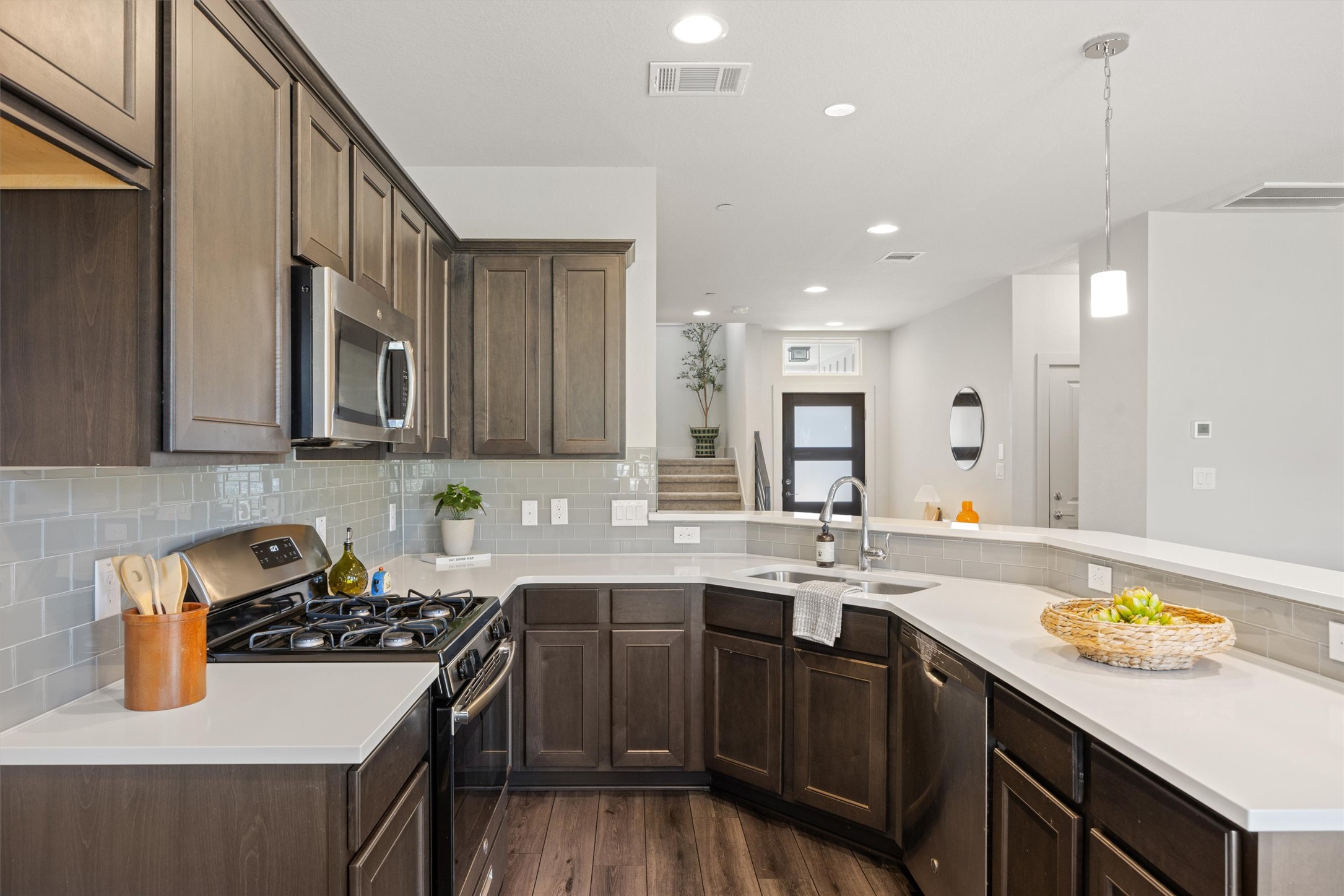 2056 Local Rebel Street Leander, TX 78641 - Photo 13 of 40 a kitchen with a sink a stove and cabinets