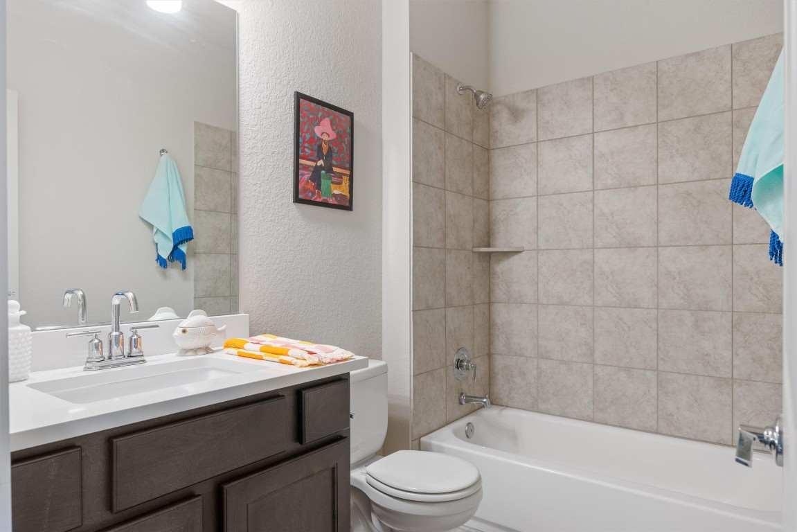 2056 Local Rebel Street Leander, TX 78641 - Photo 15 of 39 a bathroom with a sink a toilet and shower