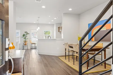 a view of living room with furniture and wooden floor