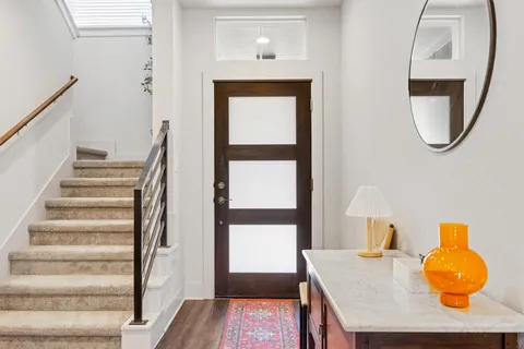 a front view of a house with wooden floor and windows