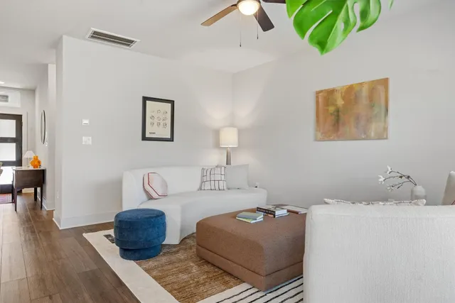 a living room with furniture and wooden floor