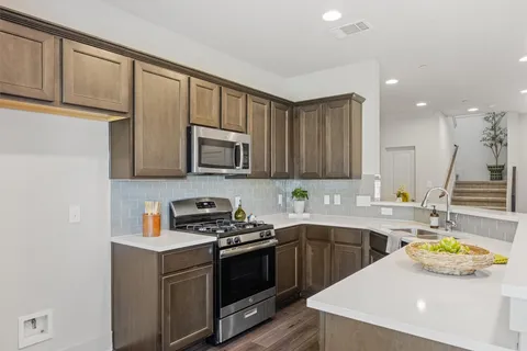 a kitchen that has a sink and a stove in it
