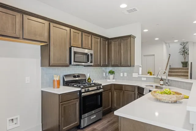a kitchen that has a sink and a stove in it