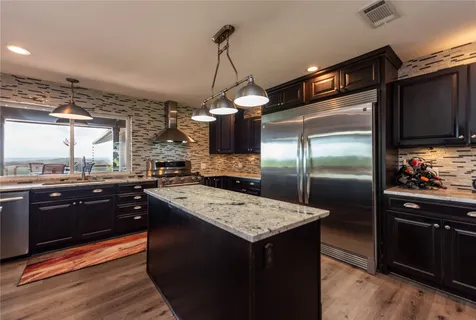 a kitchen with a refrigerator and a sink