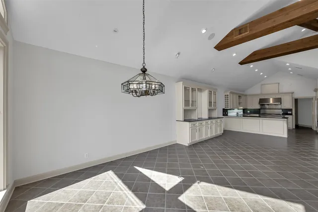 a view of an empty room with glass door and windows