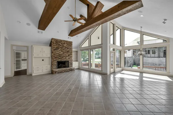 a large kitchen with stainless steel appliances granite countertop a refrigerator and a stove