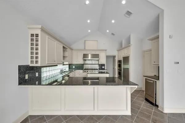 a kitchen with a sink stove and cabinets
