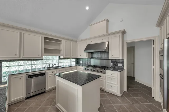 a kitchen with a sink stove and cabinets