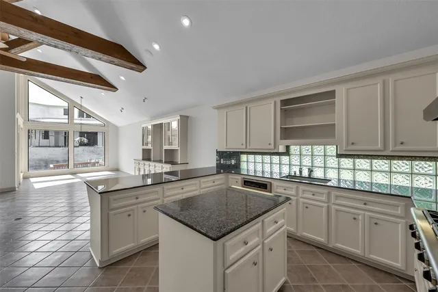 a spacious bedroom with a bed and a chandelier