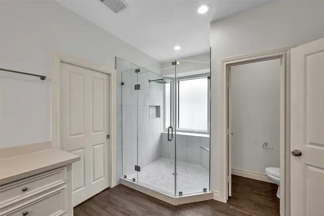 a spacious bedroom with a bed a couch and a window