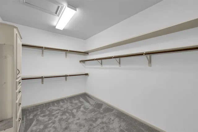 a spacious bedroom with a bed and a large window