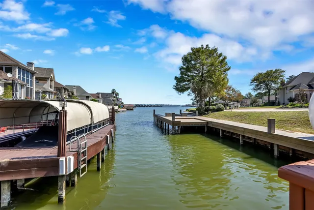 a view of a swimming pool with lawn chairs