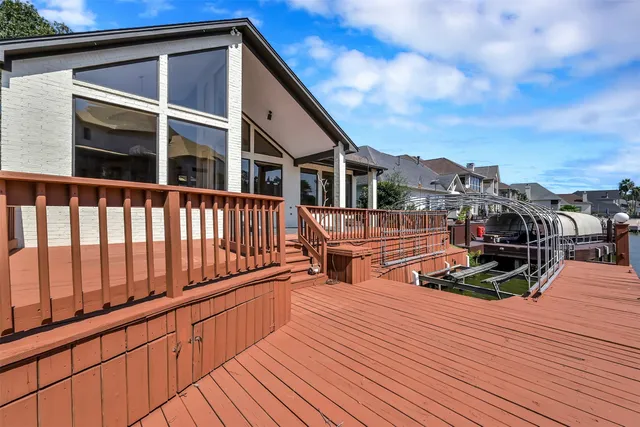 a view of a balcony with chairs and wooden floor