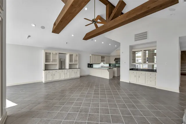 a dining room with furniture potted plants and wooden floor