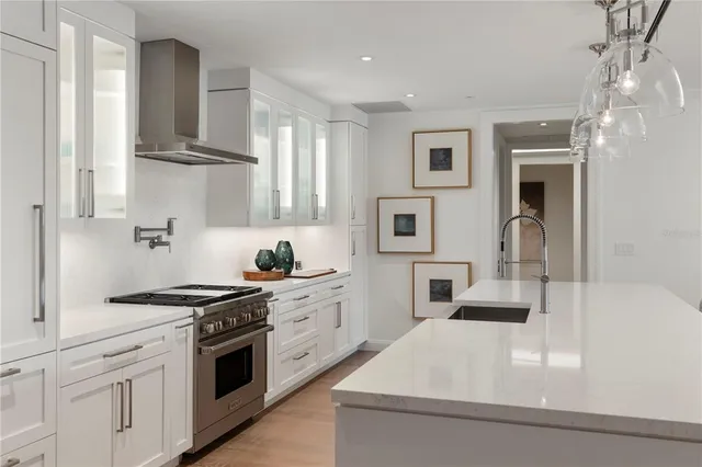 a kitchen with stainless steel appliances a sink stove and cabinets