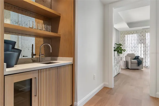 a living room with furniture a window and a potted plant