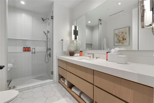 a bathroom with a sink mirror vanity and toilet