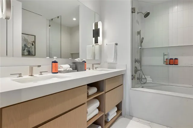 a bathroom with a sink double vanity and a mirror
