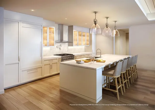 a kitchen with a sink chairs and white cabinets