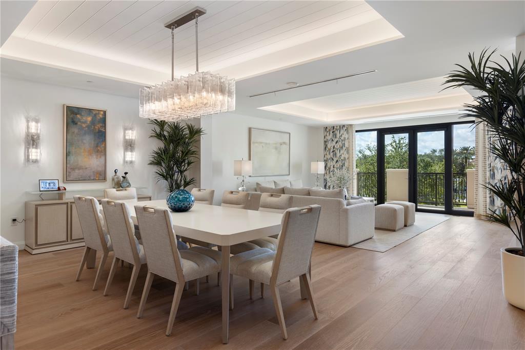 10160 Autumn Mist Lane, Unit 302 Orlando, FL 32836 - Photo 8 of 46 a dining room with furniture wooden floor and a chandelier