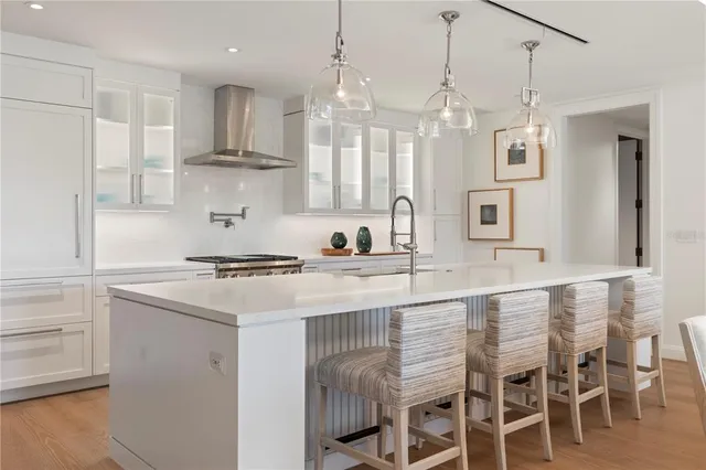 a kitchen with stainless steel appliances granite countertop a sink a stove and a refrigerator