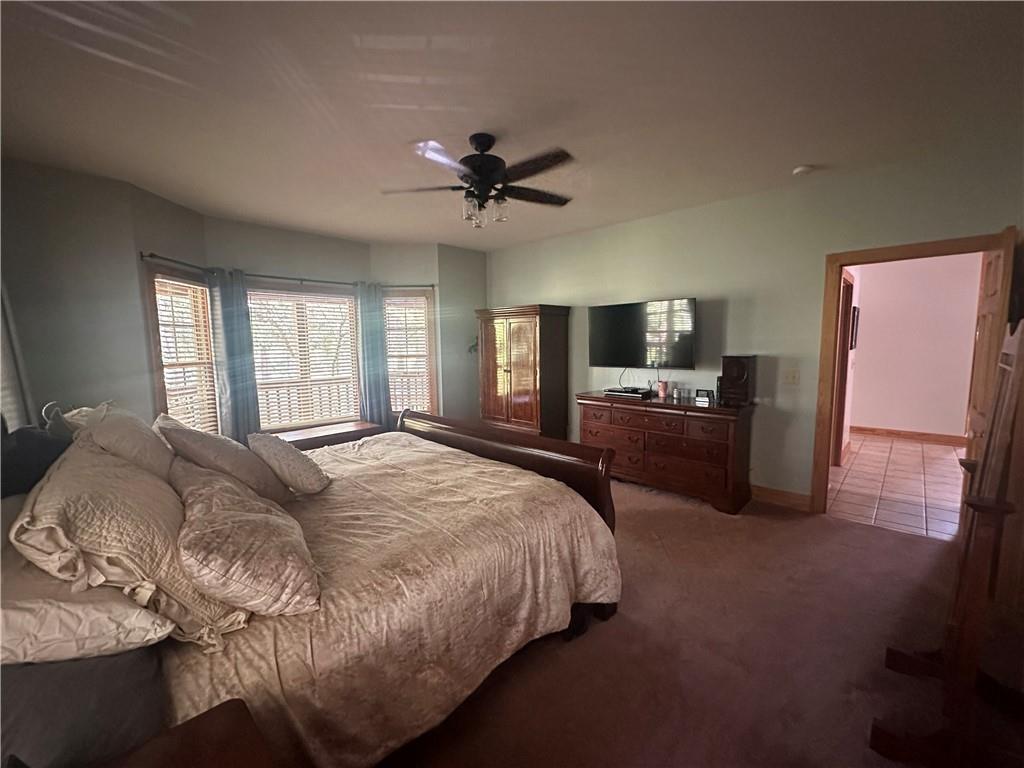 8275 Pea Ridge Road Cornelia, GA 30531 - Photo 16 of 52 a spacious bedroom with a bed and a television