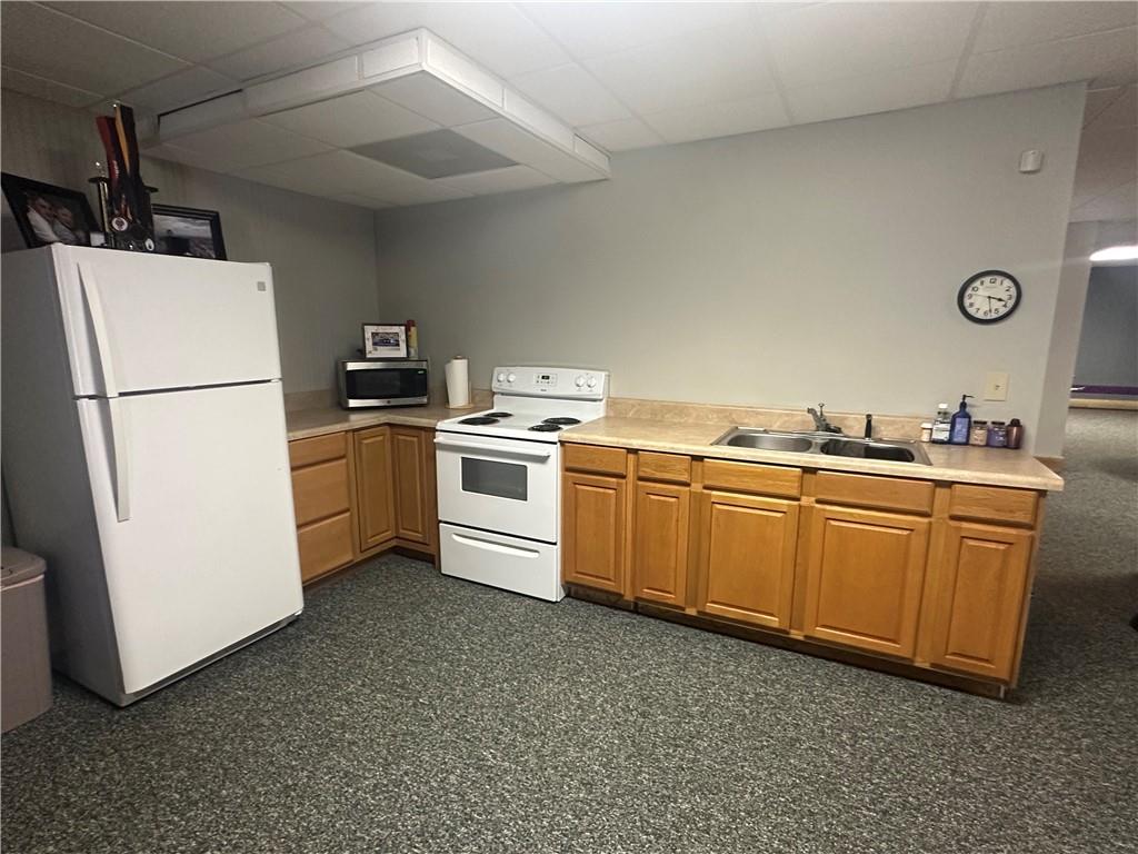8275 Pea Ridge Road Cornelia, GA 30531 - Photo 28 of 52 a kitchen with cabinets a sink and white stainless steel appliances