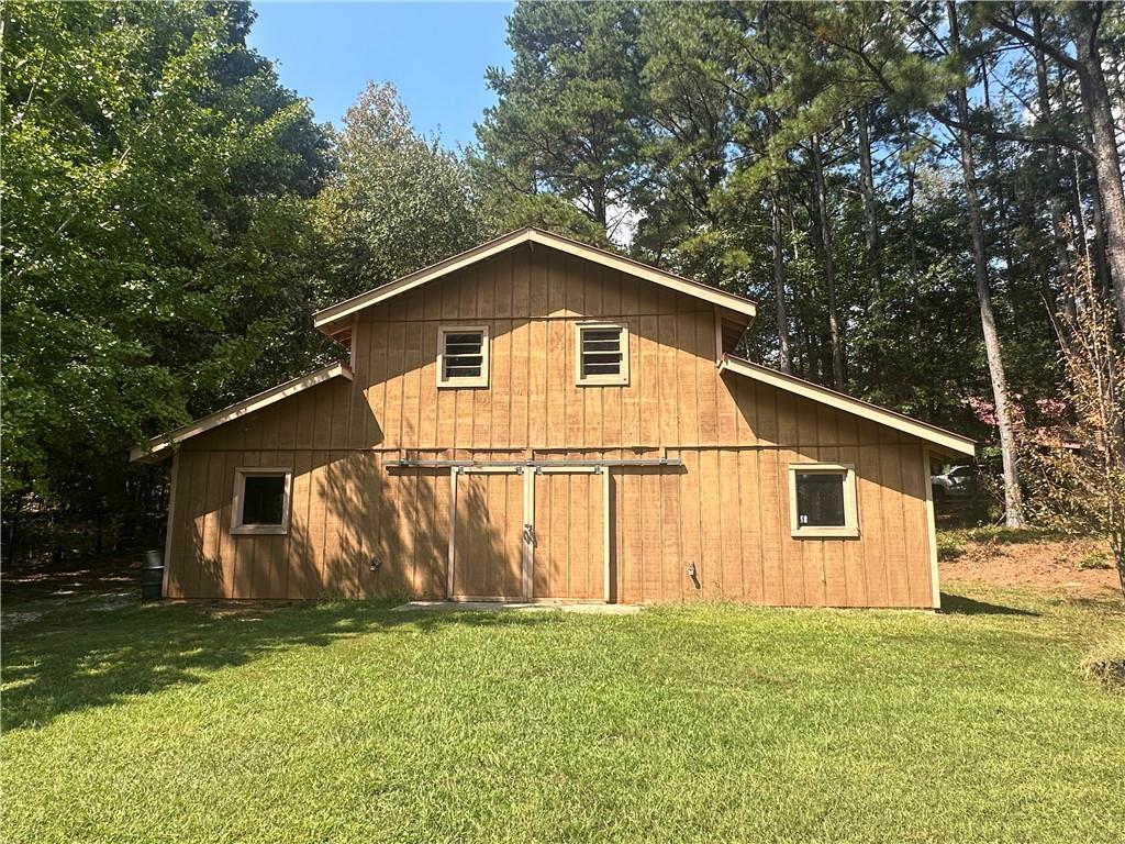 8275 Pea Ridge Road Cornelia, GA 30531 - Photo 46 of 52 a view of a backyard with barn and green space