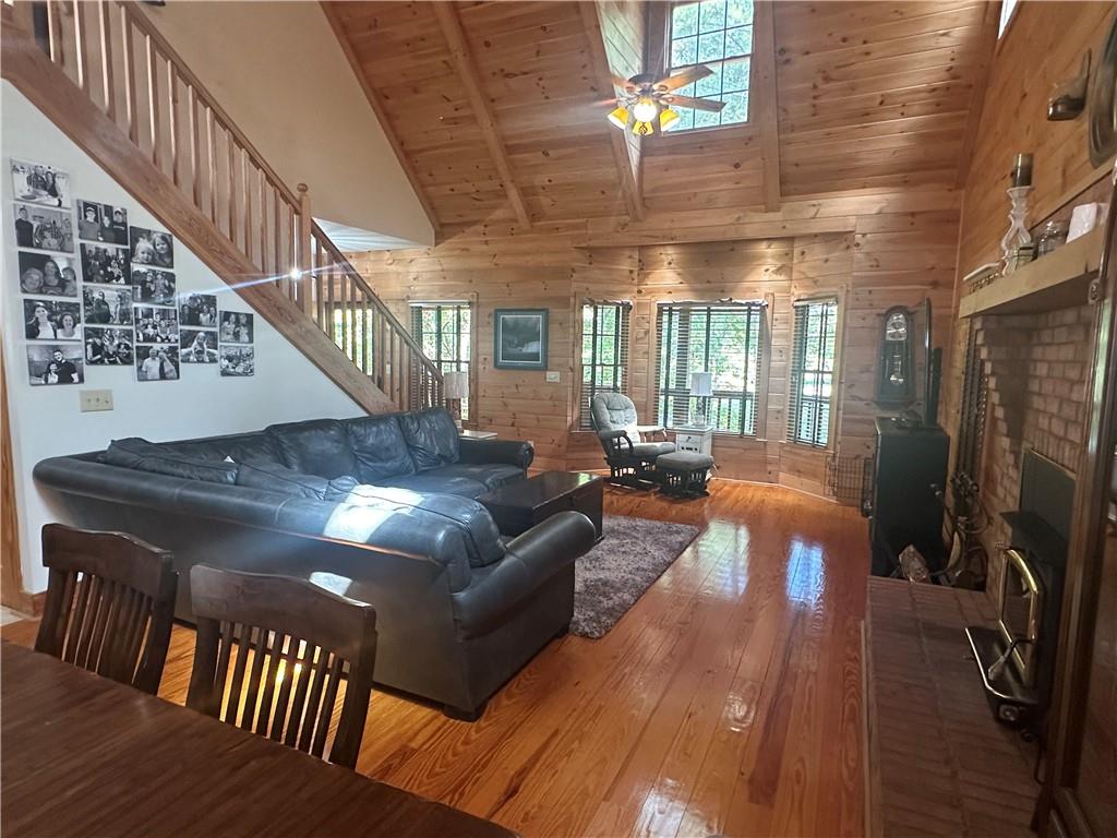 8275 Pea Ridge Road Cornelia, GA 30531 - Photo 8 of 52 a living room with patio furniture and a chandelier