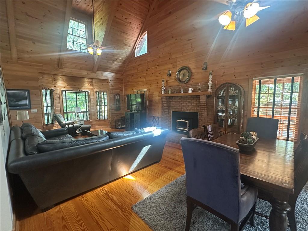 8275 Pea Ridge Road Cornelia, GA 30531 - Photo 9 of 52 a living room with fireplace furniture and a chandelier