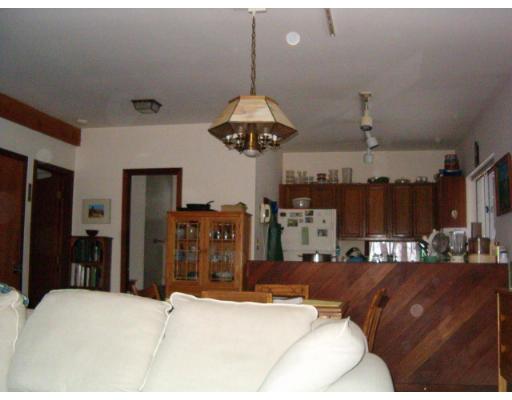 44 Falls Road Sunderland, MA 01375 - Photo 3 of 6 a living room with a couch and a chandelier