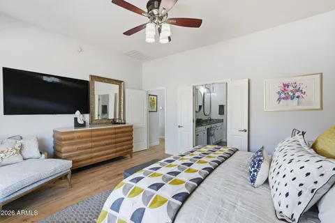 a bedroom with a bed and flat screen tv