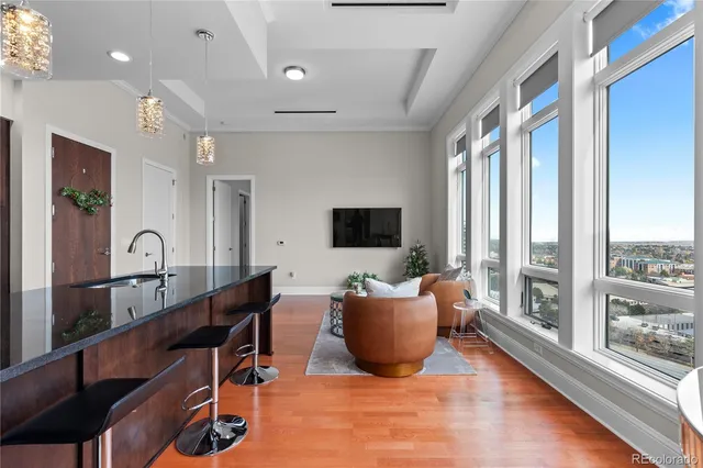 a living room with furniture tv and a large window