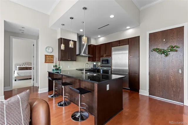 a kitchen with stainless steel appliances granite countertop a refrigerator and a stove top oven