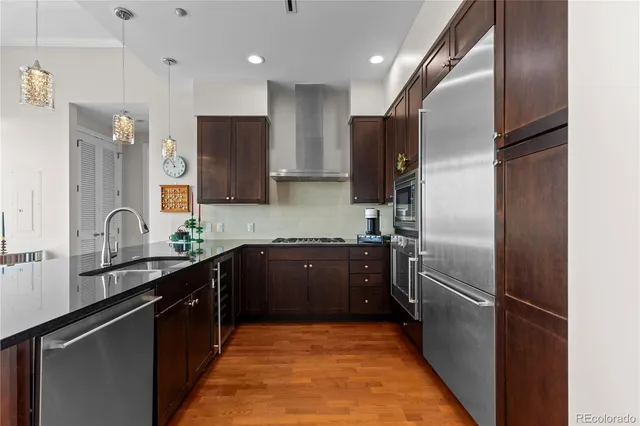 a kitchen with stainless steel appliances granite countertop a refrigerator and a sink