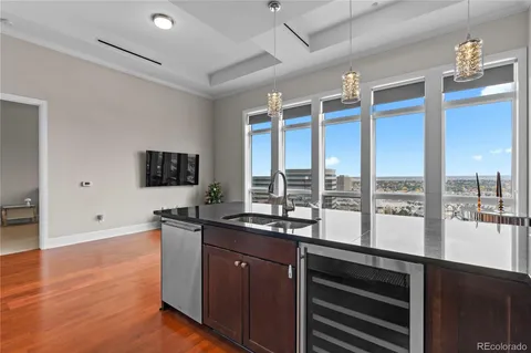 a kitchen with granite countertop a sink and a refrigerator