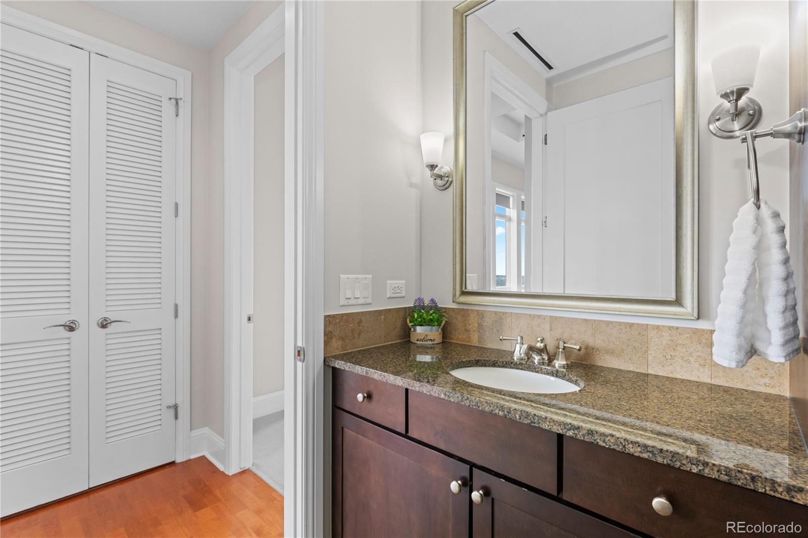 7600 Land Mark Way, Unit 1411 Greenwood Village, CO 80111 - Photo 19 of 50 a bathroom with a sink and a mirror