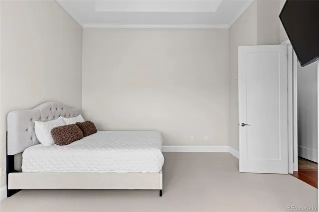 a bedroom with a bed and a tv