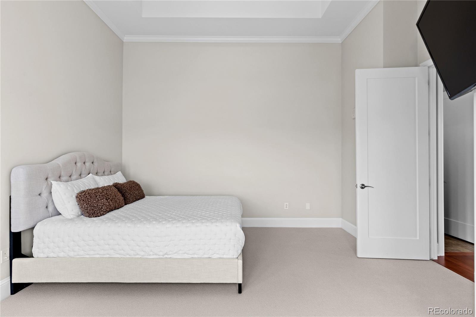 7600 Land Mark Way, Unit 1411 Greenwood Village, CO 80111 - Photo 20 of 50 a bedroom with a bed and a tv