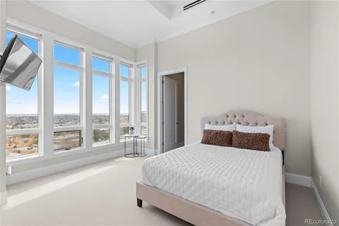 a bedroom with a large bed and a large window