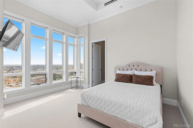 a bedroom with a large bed and a large window