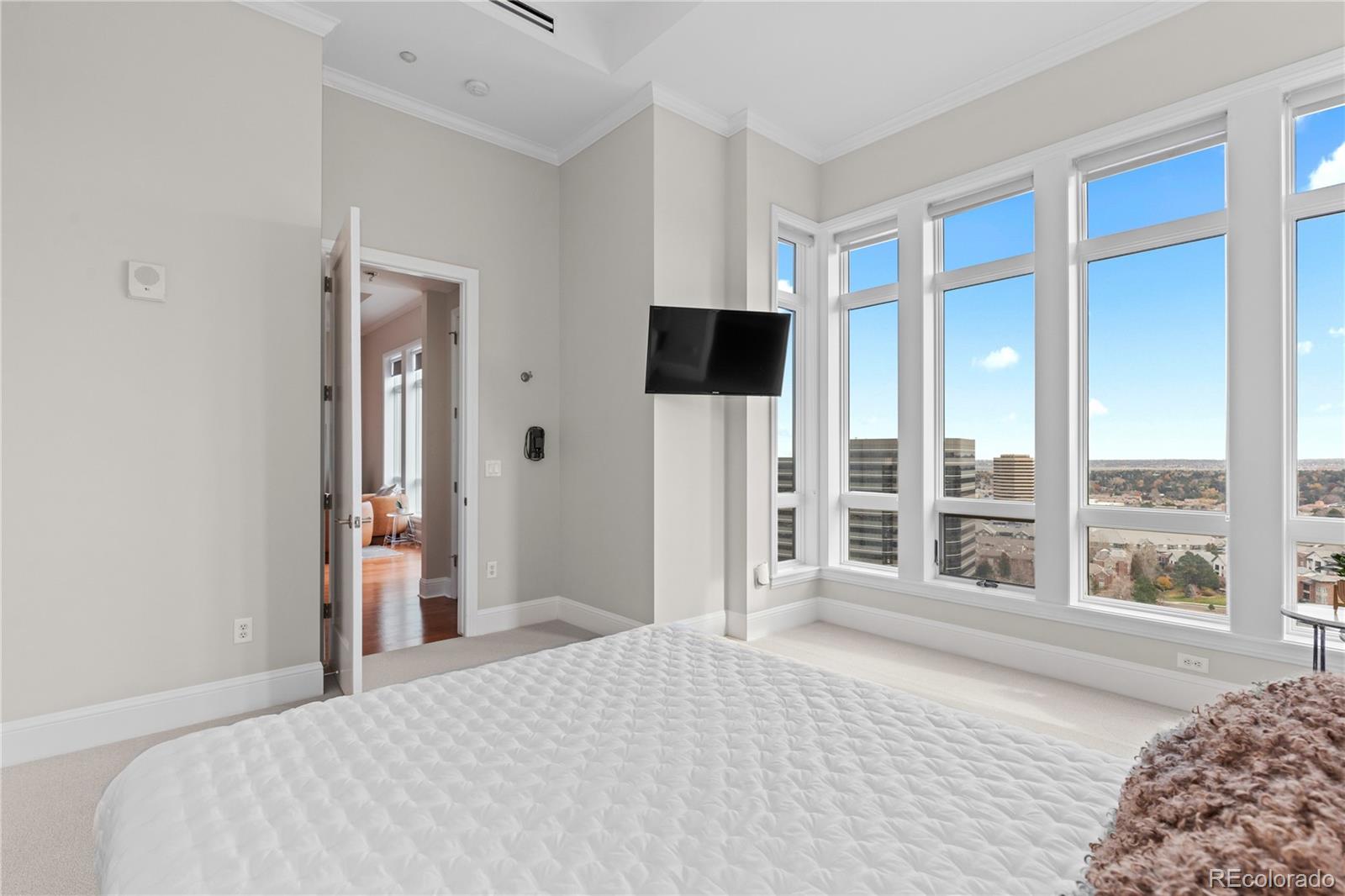 7600 Land Mark Way, Unit 1411 Greenwood Village, CO 80111 - Photo 22 of 50 a bedroom with a bed and a large window