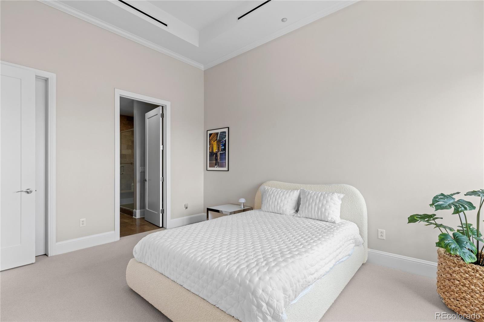 7600 Land Mark Way, Unit 1411 Greenwood Village, CO 80111 - Photo 26 of 50 a bedroom with a bed and a potted plant