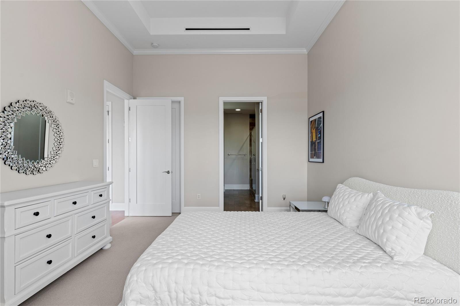 7600 Land Mark Way, Unit 1411 Greenwood Village, CO 80111 - Photo 27 of 50 a bedroom with a bed and a dresser