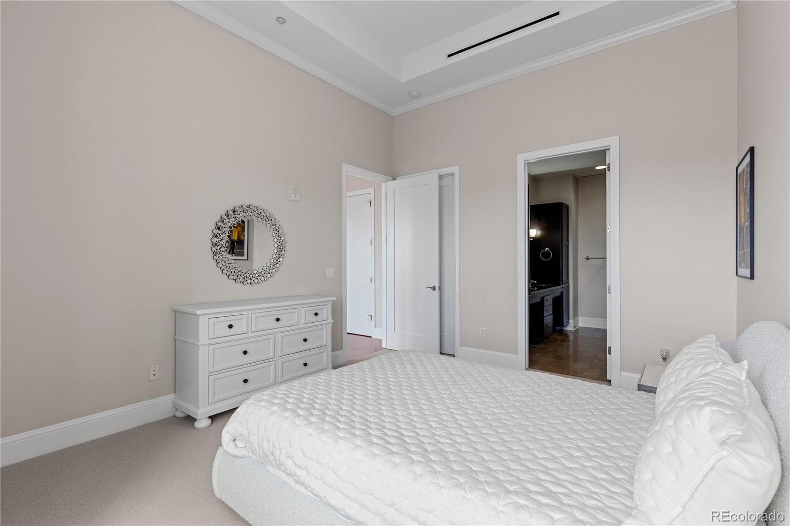 7600 Land Mark Way, Unit 1411 Greenwood Village, CO 80111 - Photo 28 of 50 a bedroom with a bed and cabinets