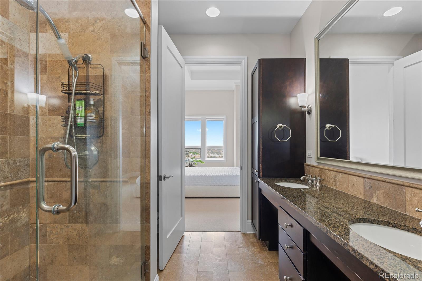 7600 Land Mark Way, Unit 1411 Greenwood Village, CO 80111 - Photo 31 of 50 a bathroom with a granite countertop shower vanity and a sink