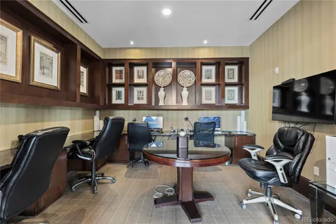 a work room with furniture and a flat screen tv