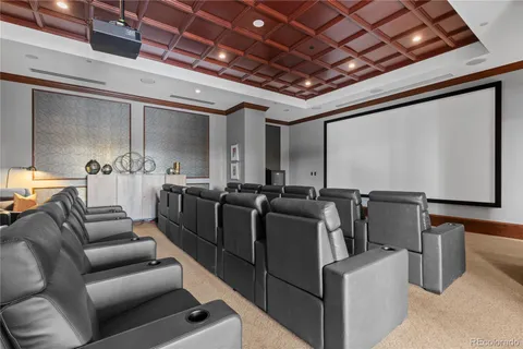 a media room with lots of chairs and a projector